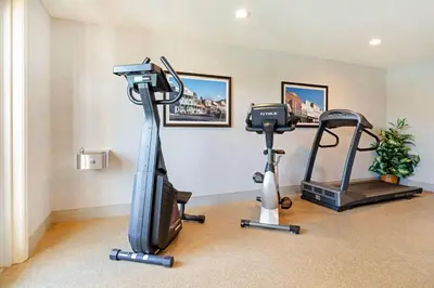 a gym with two exercise bikes and a treadmill at Best Western Cedar Inn & Suites in Angels Camp
