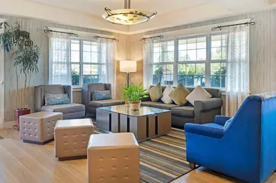 a living room with a couch and a table at Best Western Cedar Inn & Suites in Angels Camp