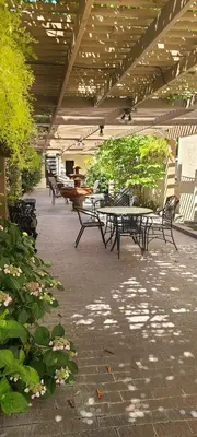 a row of tables and benches in a patio at Dow Villa Motel in Lone Pine
