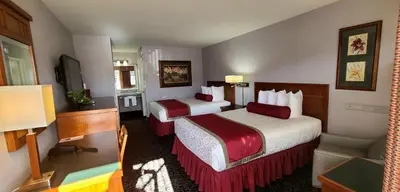 a hotel room with two beds and a television at Dow Villa Motel in Lone Pine