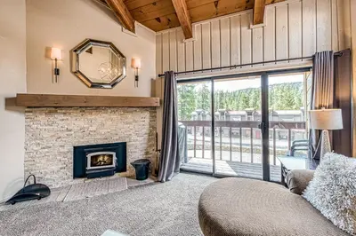 a living room with a fireplace and a couch at Courchevel 57 in Mammoth Lakes