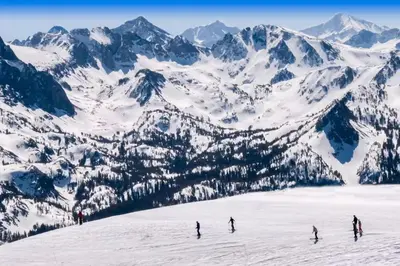 a group of people skiing down a snow covered mountain at Courchevel 57 in Mammoth Lakes