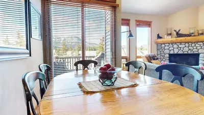 a dining room table with a bowl of fruit on it at Snowcreek V #997 Condo in Mammoth Lakes
