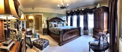 a large bedroom with a large bed and a living room at The Inn on Knowles Hill Bed & Breakfast Hotel in Sonora