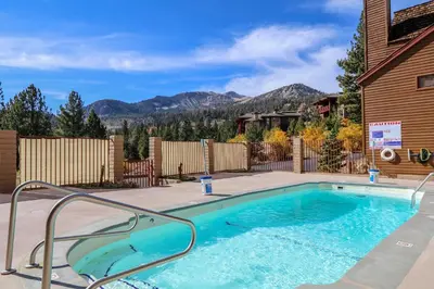 a swimming pool in a yard with a house at Aspen Creek #306 Condo in Mammoth Lakes