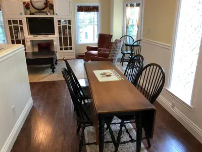 a dining room and living room with a table and chairs at Carriage House at Yosemite in Fish Camp