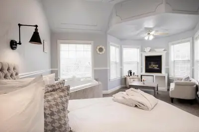 a large bedroom with a bed and a bath tub at Hounds Tooth Inn in Oakhurst