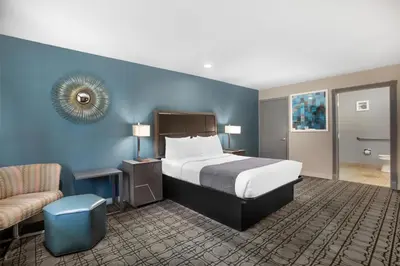 a hotel room with a bed and a chair at Best Western Big Country Inn in Coalinga