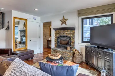 a living room with a fireplace and a tv at Lake Front Family Home at Donner in Truckee