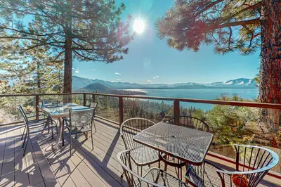 a balcony with tables and chairs and a view of the water at The Lake Labyrinth in Zephyr Cove