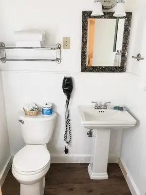 a bathroom with a toilet and a sink at El Dorado Motel in Twain Harte