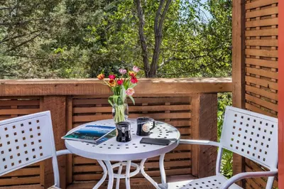 a table with a vase of flowers on a porch at Eden Vale Inn in Placerville
