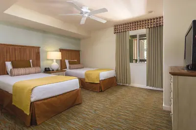 a hotel room with two beds and a flat screen tv at WorldMark South Shore in Zephyr Cove