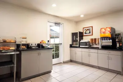 a large kitchen with white cabinets and a window at Microtel Inn & Suites Lodi in Lodi