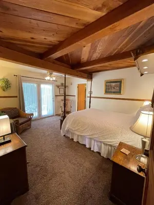 a bedroom with a large bed in a room at Berkshire Inn in Groveland