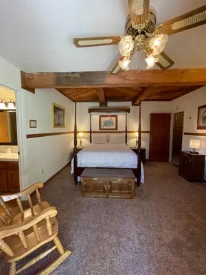 a bedroom with a bed and a ceiling fan at Berkshire Inn in Groveland