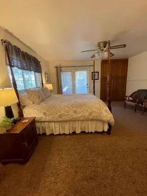 a bedroom with a bed and a ceiling fan at Berkshire Inn in Groveland