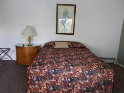 a bedroom with a bed and a picture on the wall at Atomic Inn Beatty Near Death Valley in Beatty