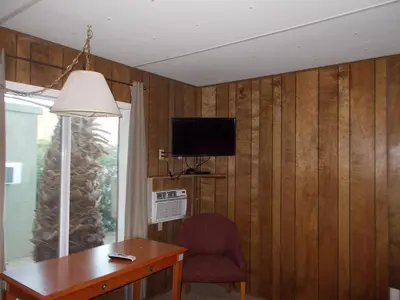 a room with a desk and a television and a chair at Atomic Inn Beatty Near Death Valley in Beatty
