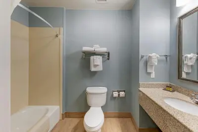 a bathroom with a toilet and a tub and a sink at Best Western Plus Wasco Inn & Suites in Wasco