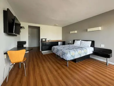 a bedroom with a bed and a flat screen tv at Motel 6-Delano, CA in Delano