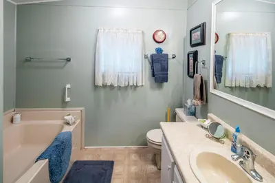 a bathroom with a tub and a toilet and a sink at Yosemite Cabin in Wawona