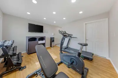 a gym with two exercise bikes and a flat screen tv at Quality Inn Kettleman City near Hwy 41 in Kettleman City