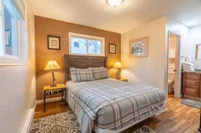 a bedroom with a bed and two lamps and a window at Birch Creek #1 - 1BR/1BA - Down Canyon in June Lake