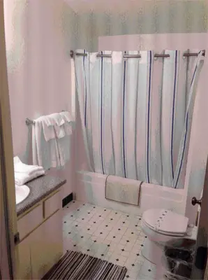 a white bathroom with a toilet and a sink at StrawberryInn River Front Resort in Strawberry