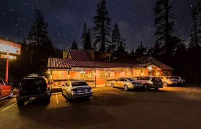 a building with cars parked in a parking lot at night at StrawberryInn River Front Resort in Strawberry