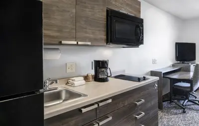 a kitchen with a sink and a microwave at My Place Hotel-Carson City, NV in Carson City