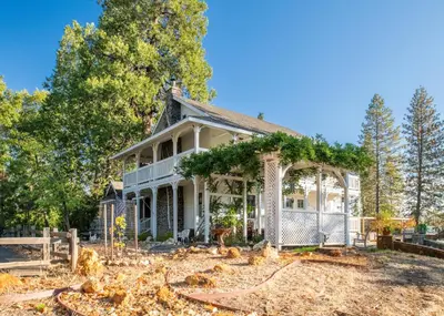 a white house with a gazebo at Inn at Sugar Pine Ranch in Groveland