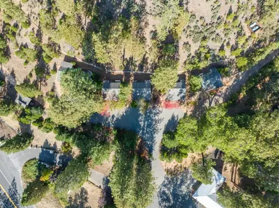 an overhead view of a river with trees and buildings at Inn at Sugar Pine Ranch in Groveland