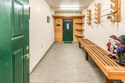 two children sitting on a bench in a hallway at Vienna Villa - 3 Bed 3 Bath Vacation home in Shaver Lake in Shaver Lake