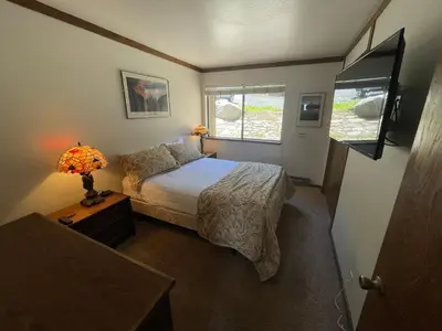 a small bedroom with a bed and a window at Mammoth Point by 101 Great Escapes in Mammoth Lakes