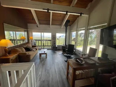 a living room with a couch and a table at Mammoth Point by 101 Great Escapes in Mammoth Lakes
