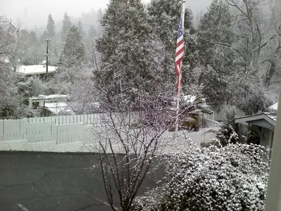 an american flag flying in front of a fence at Mother Lode Lodge in Mariposa
