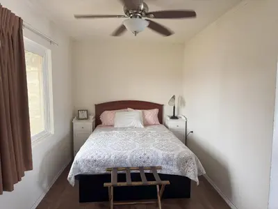 a bedroom with a bed and a ceiling fan at Lakeshore Lodge in Wofford Heights