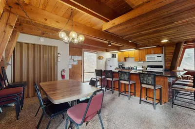 a kitchen and dining room with a wooden table and chairs at Retro Family Gathering Home in Tahoe Donner in Truckee