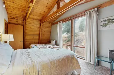 a bedroom with a bed and a large window at Retro Family Gathering Home in Tahoe Donner in Truckee