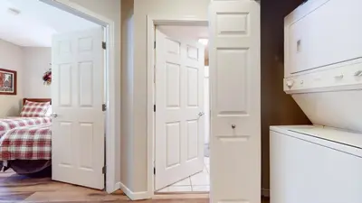 a white door in a room with a bed at Mammoth Green #120 Condo in Mammoth Lakes
