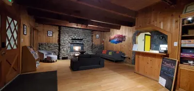 a living room with a stone fireplace and a couch at The Mammoth Inn in Mammoth Lakes