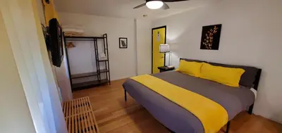 a bedroom with a large bed with yellow pillows at The Mammoth Inn in Mammoth Lakes