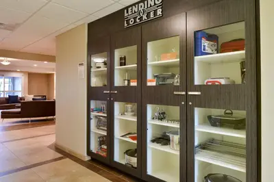 an office lobby with a library with shelves at Candlewood Suites - Lodi by IHG in Lodi