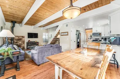a living room with a wooden table and a couch at Fairway Park Cabin in Incline Village
