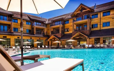 a view of the pool at a resort with tables and umbrellas at Steps From Heavenly Village & Gondola-Luxury 3Br Residence Condo in South Lake Tahoe