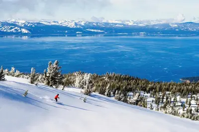 a person is skiing down a snow covered slope at Steps From Heavenly Village & Gondola-Luxury 3Br Residence Condo in South Lake Tahoe