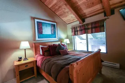 a bedroom with a bed and a window at Val D'Isere #1 Condo in Mammoth Lakes