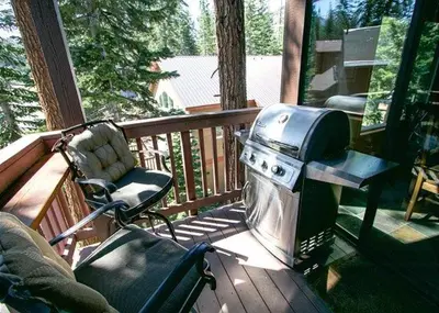 a grill and a chair on a porch at Val D'Isere #1 Condo in Mammoth Lakes
