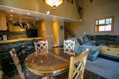a living room with a table and a couch at Val D'Isere #1 Condo in Mammoth Lakes